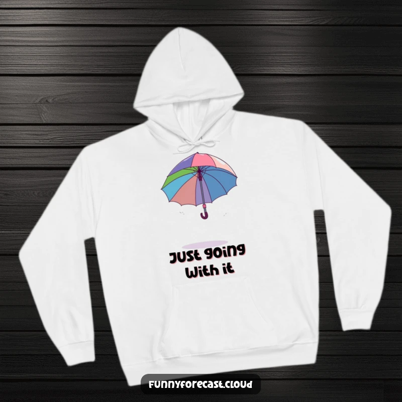 Funny dancing umbrella comically spinning out of control in a gentle breeze, showcasing humorous chaos on a cozy hoodie.