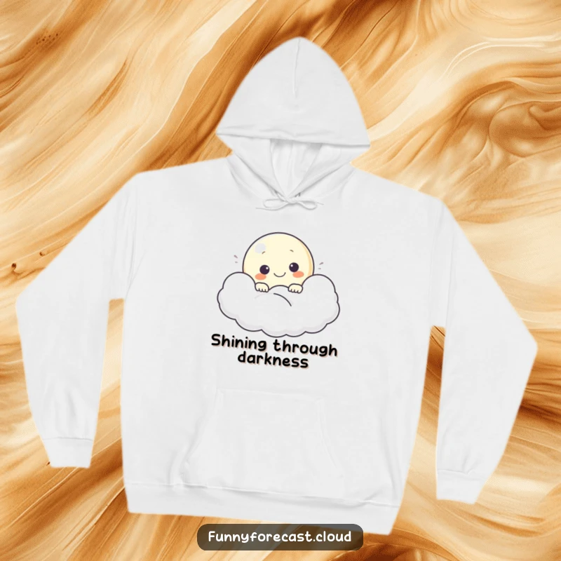 Funny hoodie depicting a smiling moon character peeking from a cloud, offering warmth and gentle cheer.
