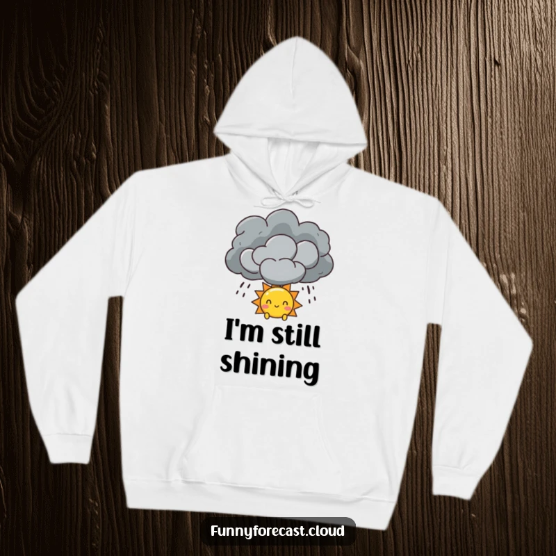 Funny Sun and Storm Cloud Hoodie showing a sun character peeking out from a dramatic storm cloud, symbolizing hope and comfort.